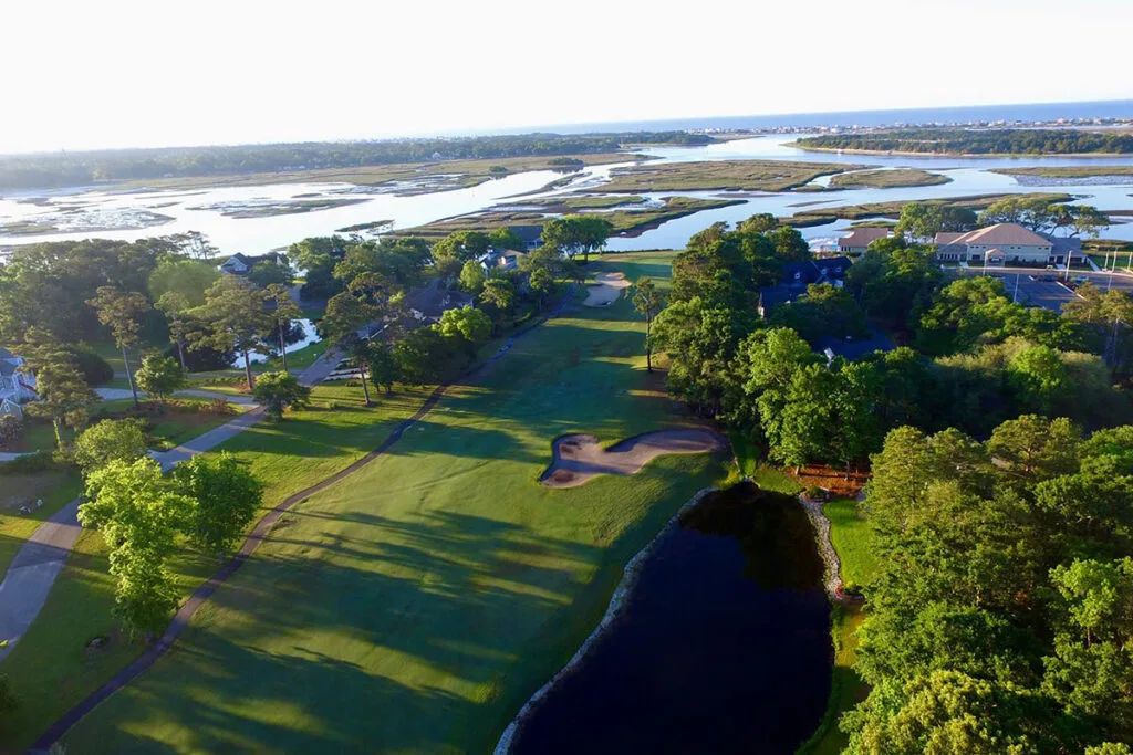 Aerial view of Lockwood Folly golf course surrounded by lush greenery and coastal waterways.