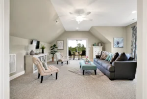 Bright modern living room with neutral decor, gray sofa, and natural light.