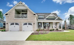 Modern white brick suburban house with double garage, covered porch, and lush green lawn.