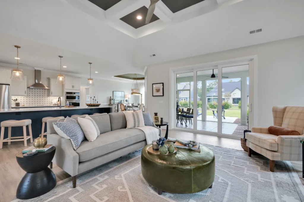 Bright modern open-concept living room and kitchen with natural light and neutral contemporary décor.