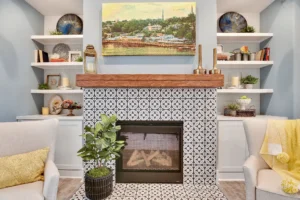 Cozy modern farmhouse living room with black-and-white tiled fireplace and warm decorative accents.