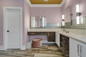 Modern lavender bathroom with yellow ceiling, wood vanity, and rose stool makeup station.