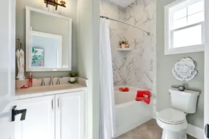 Bright modern bathroom with white vanity, marble shower, and natural light for a clean elegant look.