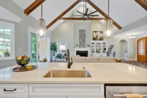 Bright open-concept kitchen and living room with quartz island, vaulted ceilings, and cozy modern décor.