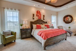 Cozy coral bedroom with carved wooden bed, rustic accents, and warm inviting lighting.