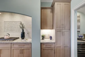 Modern light wood kitchen with granite countertops and soft lighting for a warm contemporary look.