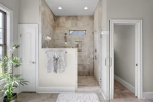 Modern master bathroom with beige walk-in shower, glass enclosure, and spa-inspired design.