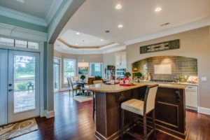Bright open-concept kitchen with island, hardwood floors, and large windows filled with natural light.
