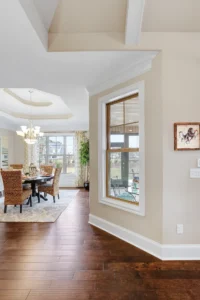Bright open-concept dining room with warm wood floors, natural light, and elegant modern decor.