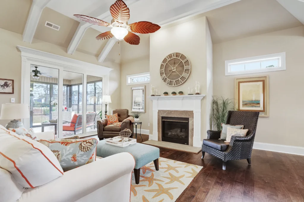 Airy coastal living room with vaulted ceilings, fireplace, natural textures, and seaside-inspired decor.