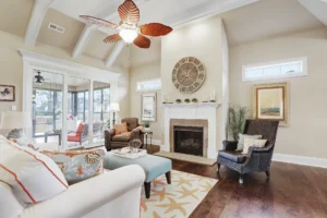 Airy coastal living room with vaulted ceilings, fireplace, natural textures, and seaside-inspired decor.