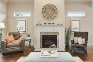 Cozy modern farmhouse living room with white fireplace, rustic clock, and warm neutral décor.