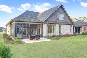 Modern suburban home with brick and siding exterior, screened patio, and landscaped yard.