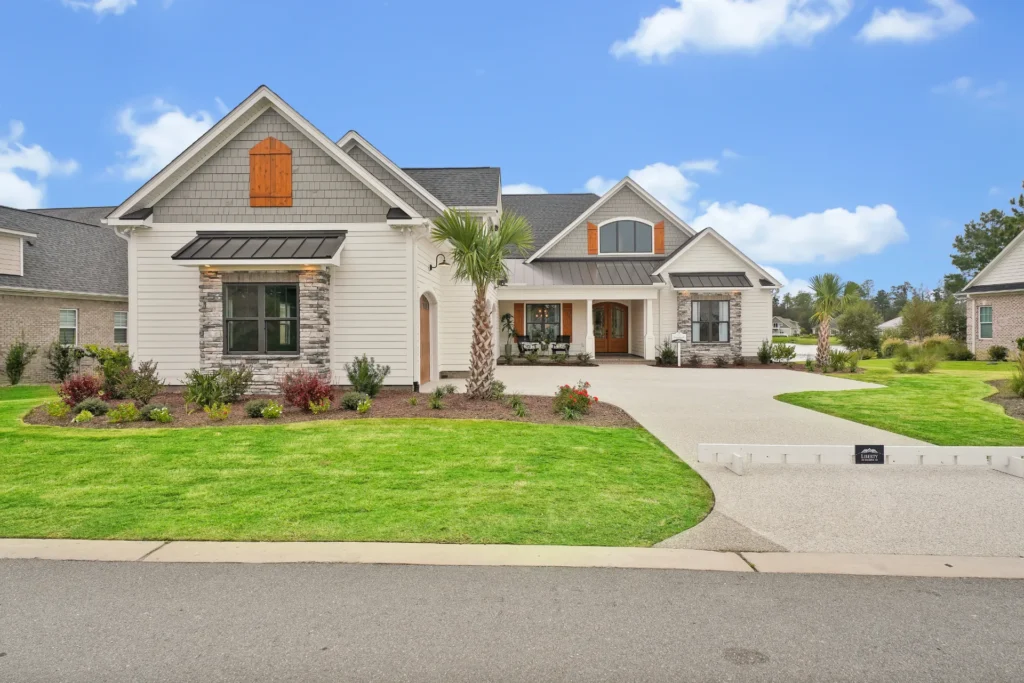 Modern suburban house with stone accents, palm tree, and inviting landscaped front yard.