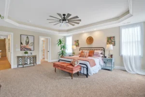 Modern neutral primary bedroom with warm terracotta accents and elegant contemporary décor.