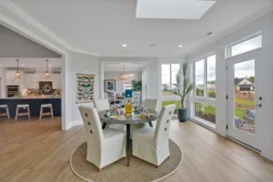 Bright modern open-concept dining and kitchen with natural light and contemporary decor.
